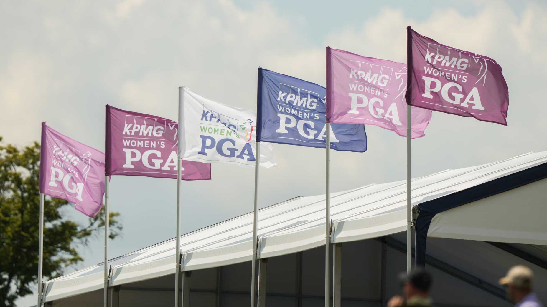 A series of KPMG Women's PGA Championship flags fly over grandstand during tournament
