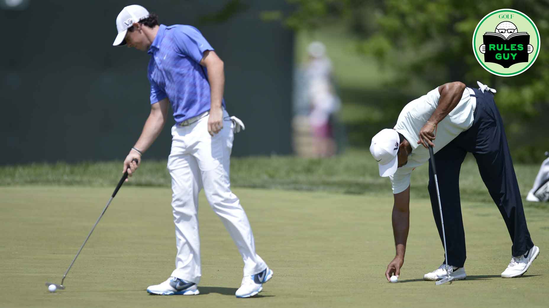 Tiger Woods (R) prepares to putt as Rory McIlroy of Northern Ireland taps his ball in on the third green during the third round of the US Open at Merion Golf Club on June 15, 2013 in Ardmore, Pennsylvania.