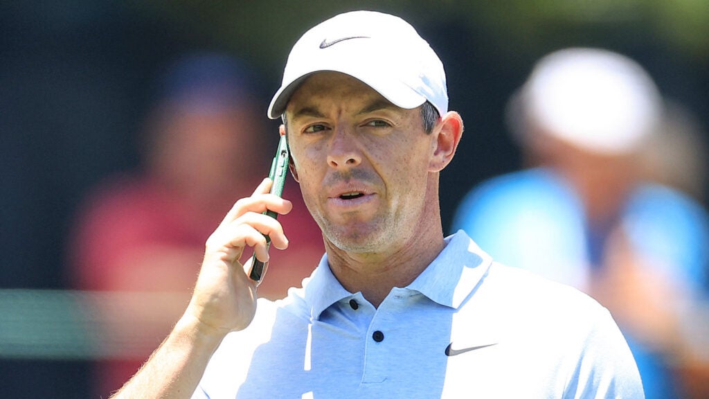 Rory McIlroy of Northern Ireland takes a phone call during his practice round prior to the 2024 U.S. Open on the No.2 Course at Pinehurst Resort