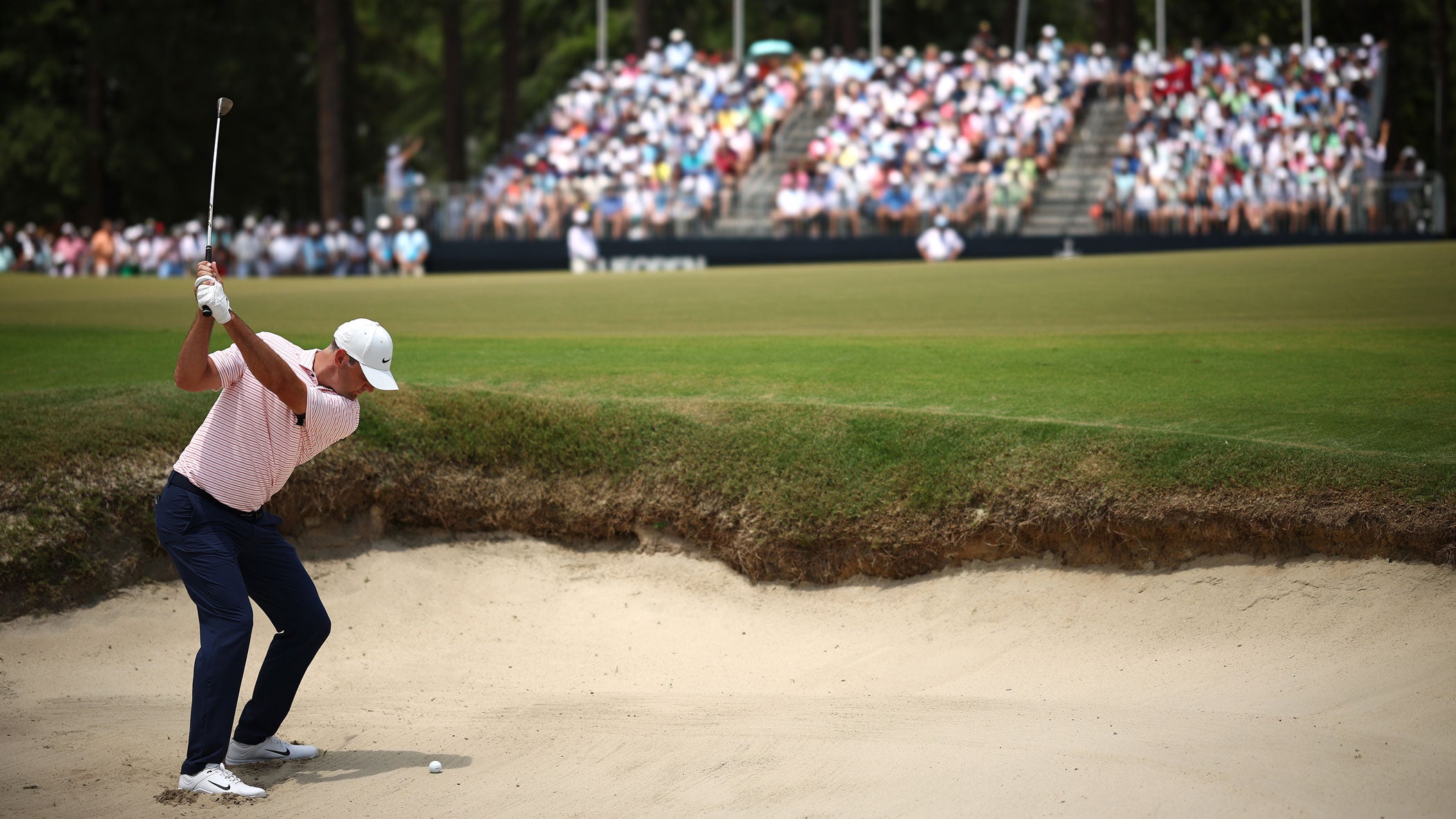 Scottie Scheffler of the United States plays a shot from a bunker on the third hole during the first round of the 124th U.S. Open at Pinehurst Resort