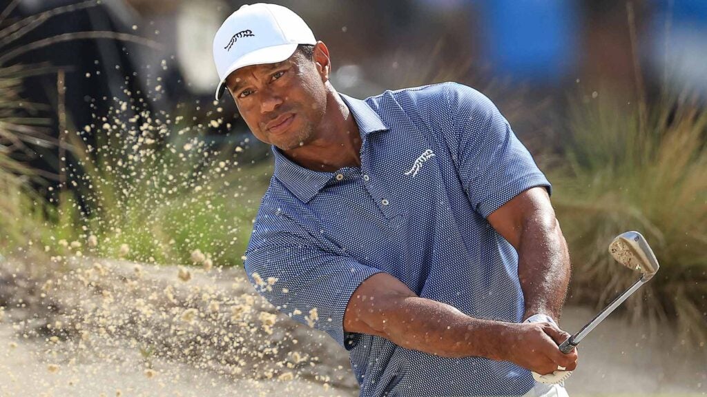 tiger woods hits out of a bunker during a practice round for the 2024 u.s. open at pinehurst no. 2