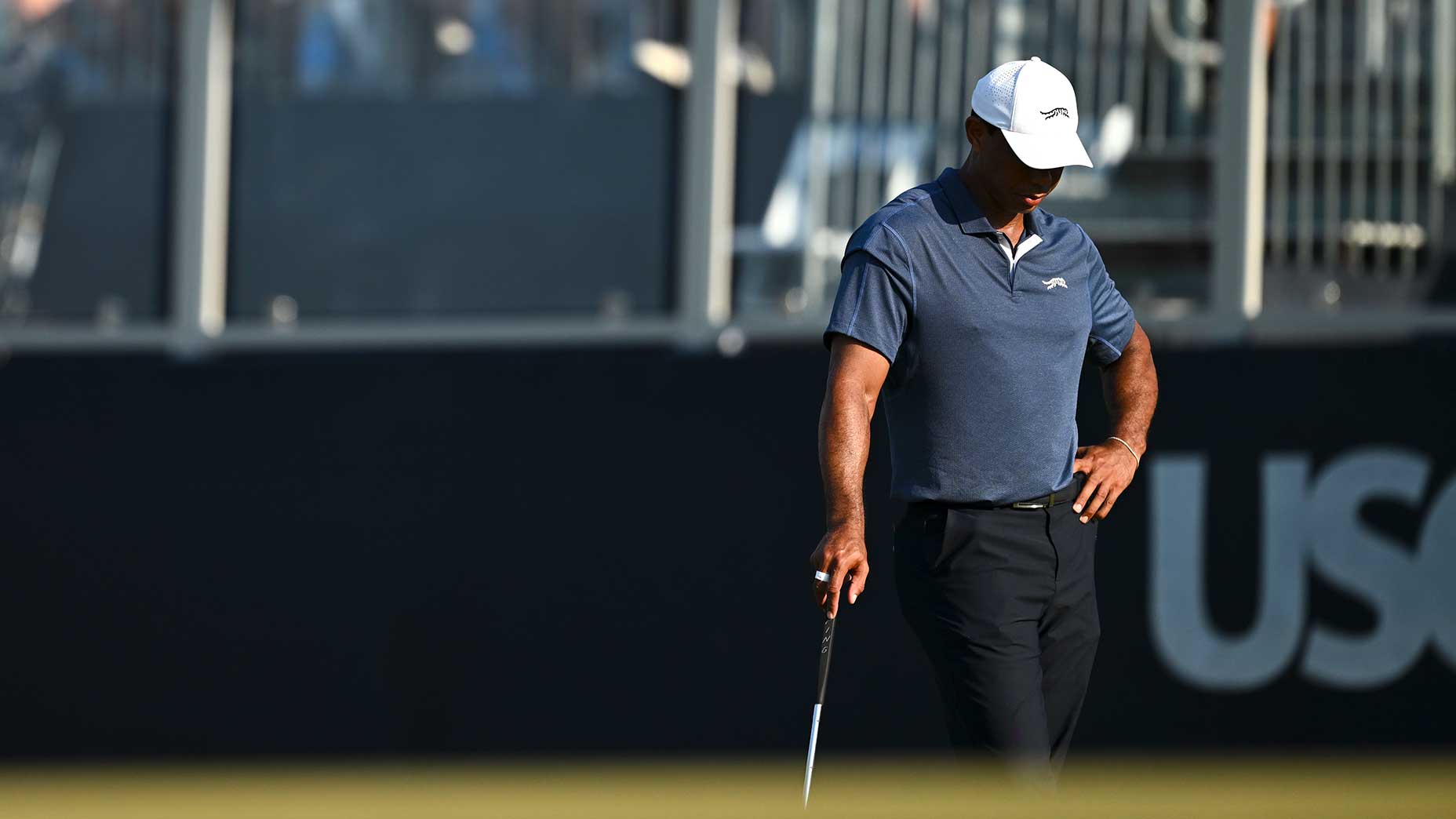 Tiger Woods looks at the ground while standing on a green during the 2024 U.S. Open.
