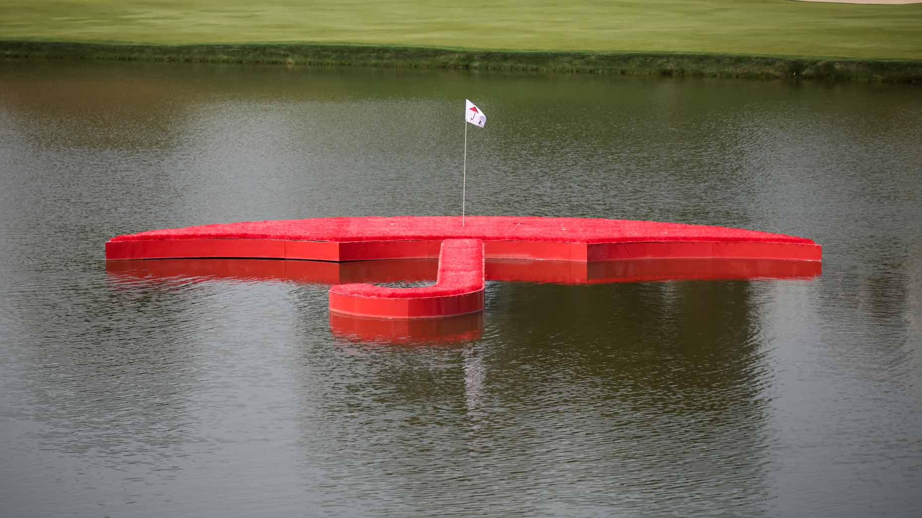 An umbrella-shaped floating green in pond at 2024 Travelers Championship