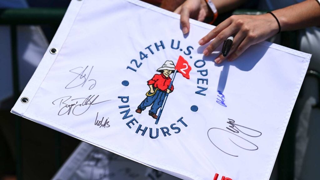 U.S. Open fans hold 2024 flag with signatures from pros at Pinehurst