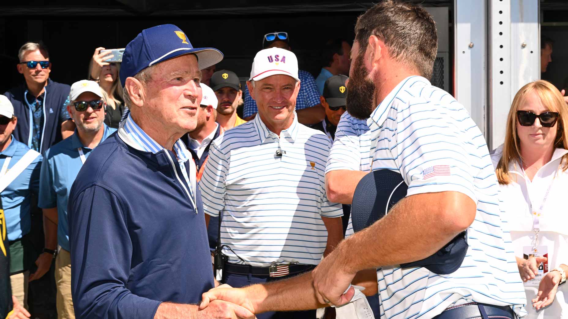 Former President George W. Bush shakes hands with U.S. Team player Cameron Young on the first tee during the second round of Presidents Cup at Quail Hollow September 23, 2022, in Charlotte, North Carolina.