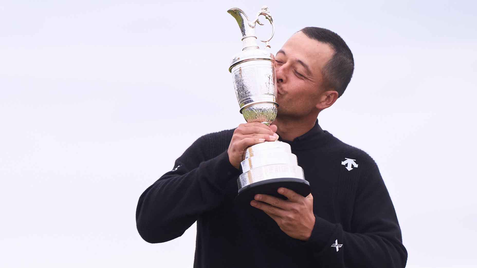 Xander Schauffele of the United States kisses the Claret Jug on the 18th green in celebration of victory on day four of The 152nd Open championship at Royal Troon on July 21, 2024 in Troon, Scotland.
