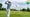 Amateur golfer swings golf club on golf course