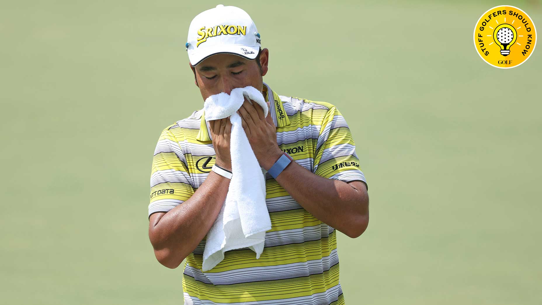 hideki matsuyama wipes his face with a towel