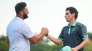 joaquin niemann and jon rahm exchange an epic handshake at a LIV Golf event