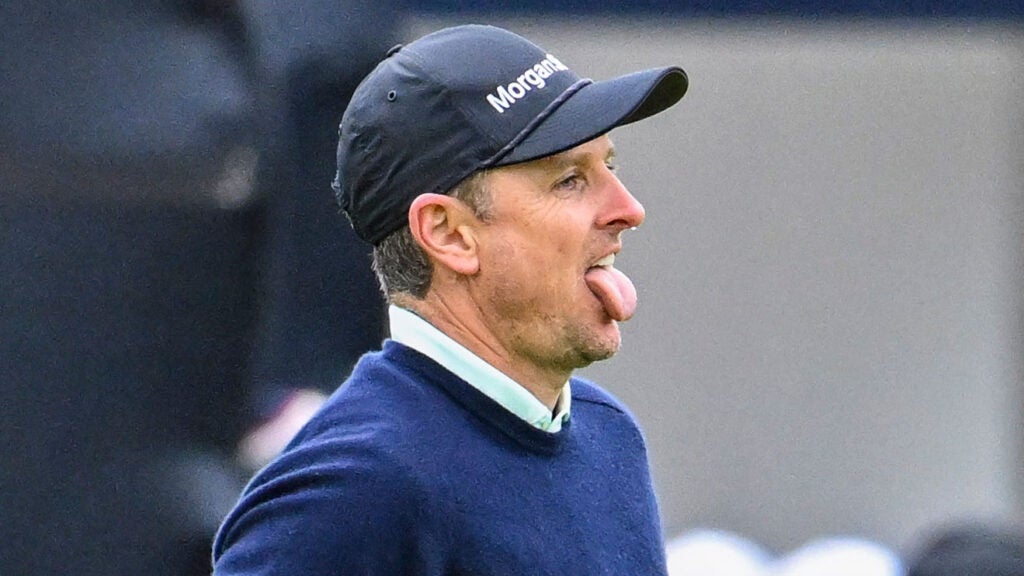 Justin Rose of England reacts and sticks his tongue out after making a par putt on the 18th hole green during the third round of The 152nd Open Championship