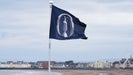 Flag flies over beach at 2024 Open Championship at Royal Troon