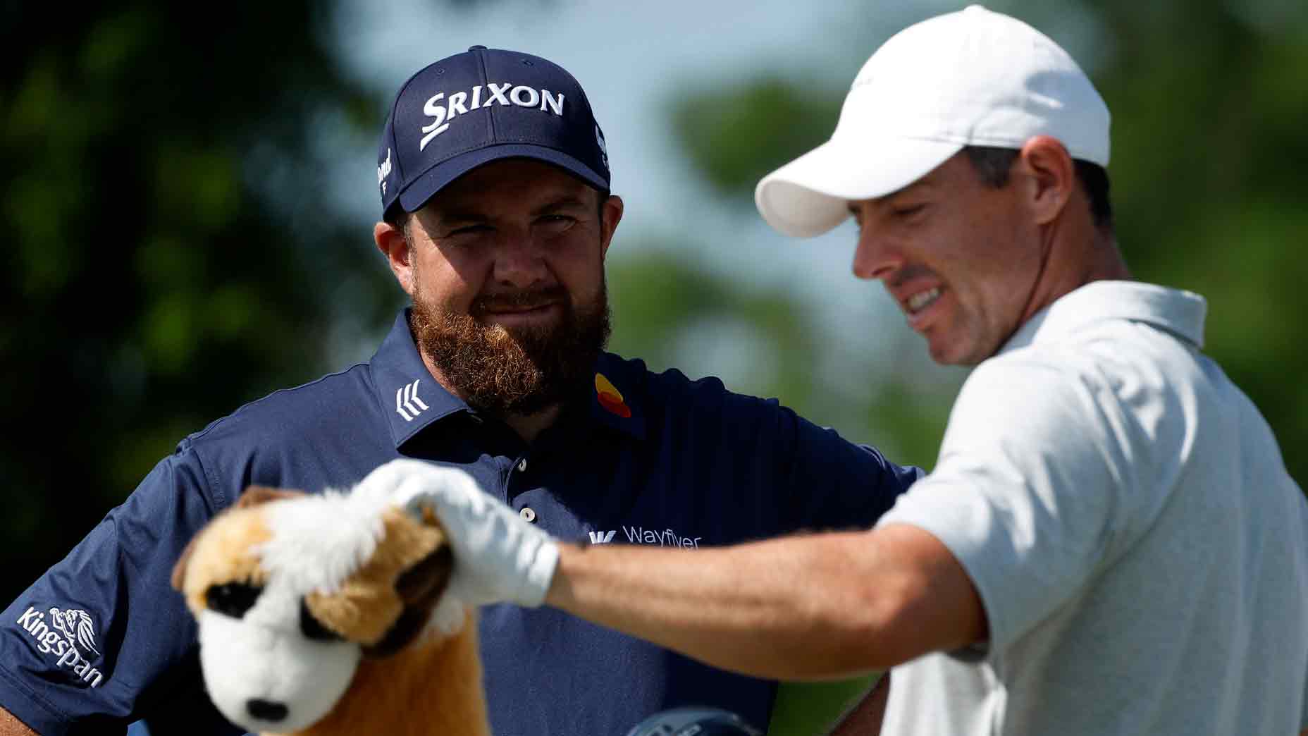 2019 Open Championship winner Shane Lowry chats with golfer Rory McIlroy on the golf course