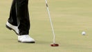 hane Lowry of Ireland taps down a spike mark before hitting a crucial par putt on the par 4, 17th hole during the final round of the Abu Dhabi HSBC Golf Championship at the Abu Dhabi Golf Club