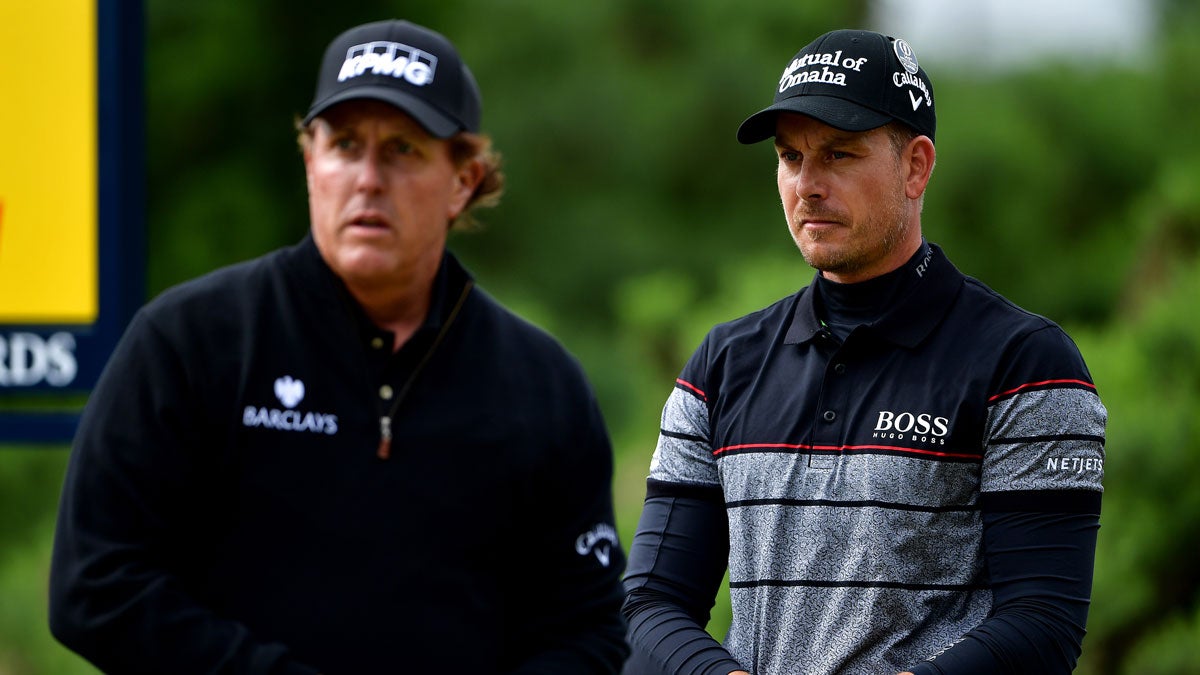 Henrik Stenson of Sweden and Phil Mickelson of the United States look thoughtful as they wait on the 12th tee during the final round on day four of the 145th Open Championship at Royal Troon