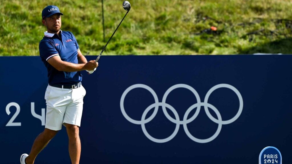 xander schauffele hits a tee shot during a practice round for the 2024 olympics
