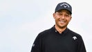 Xander Schauffele smiles with his caddie Austin Kaiser after making a birdie putt on the 16th hole green during the final round of The 152nd Open Championship at Royal Troon on July 21, 2024 in Troon, Scotland.
