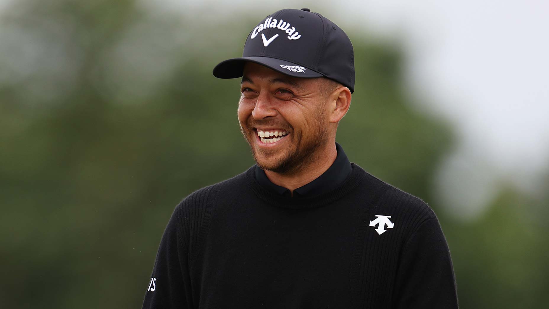 Pro golfer Xander Schauffele smiles for the camera at the 2024 Genesis Scottish Open