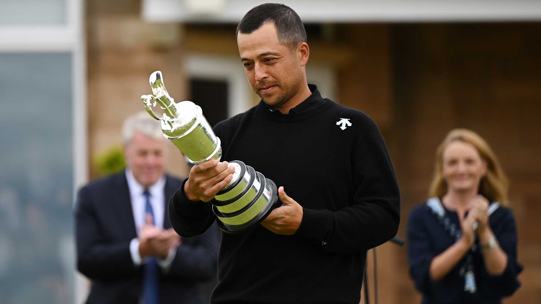 Xander schauffele looks at the claret jug after winning the 2024 open championship.