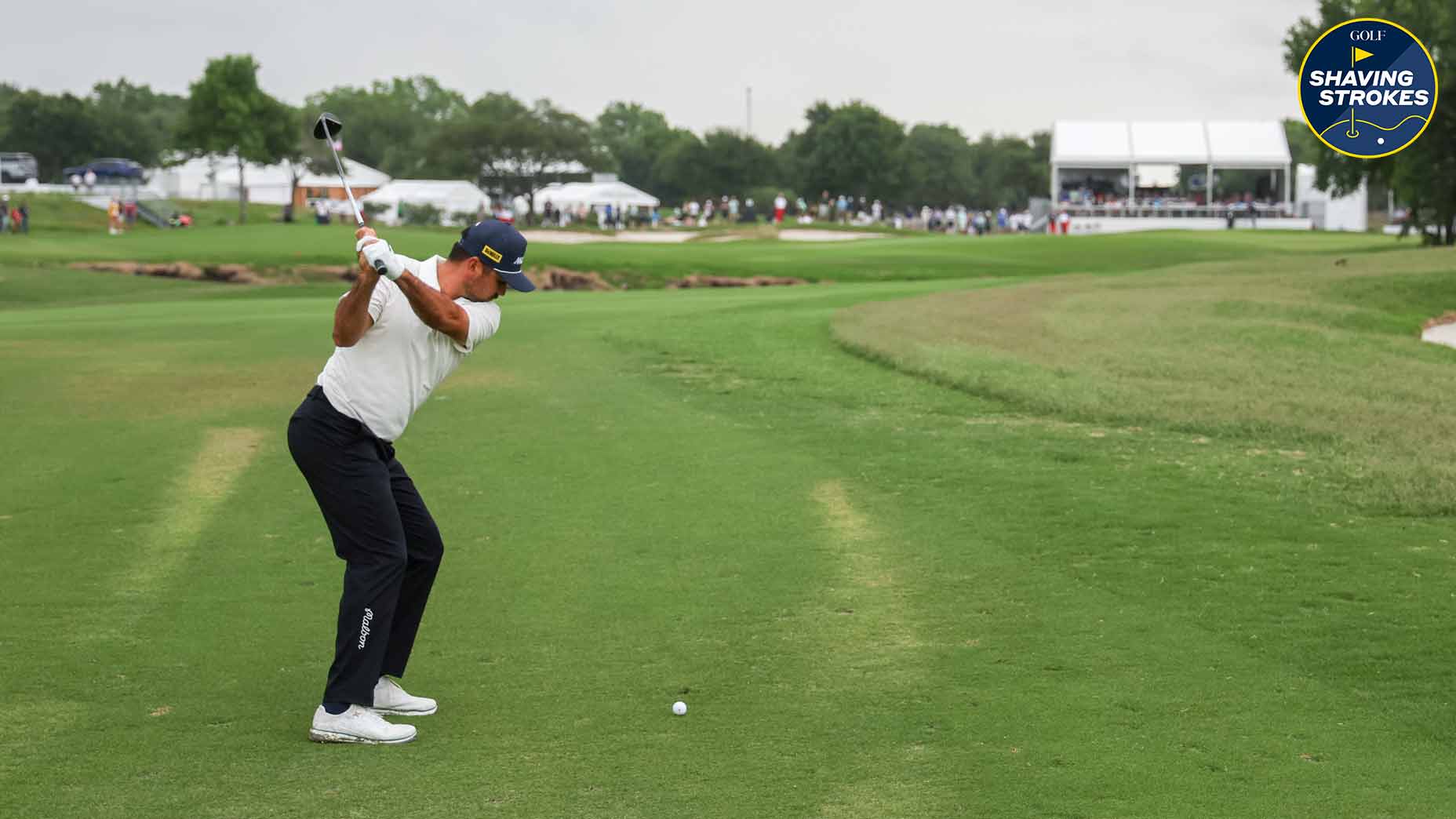 Golf pro takes club back before hitting shot at tournament