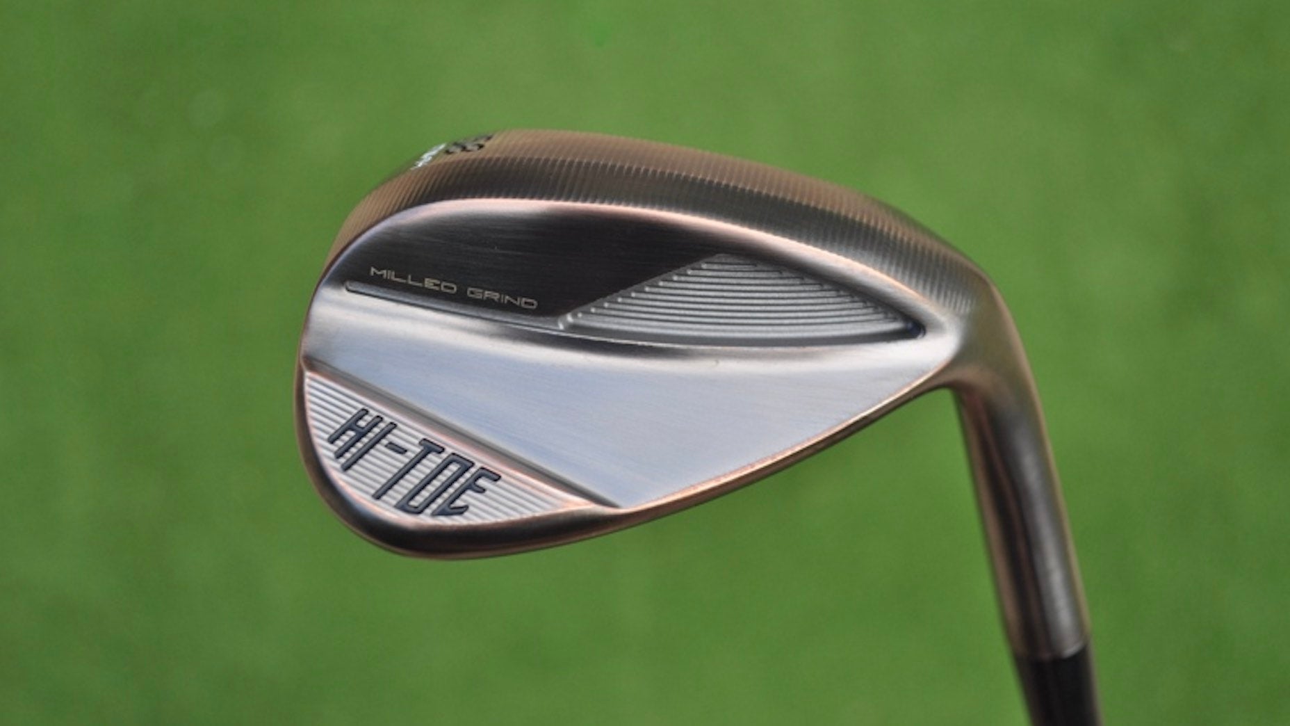 A TaylorMade Hi Toe 4 wedge pictured in hand at a golf course