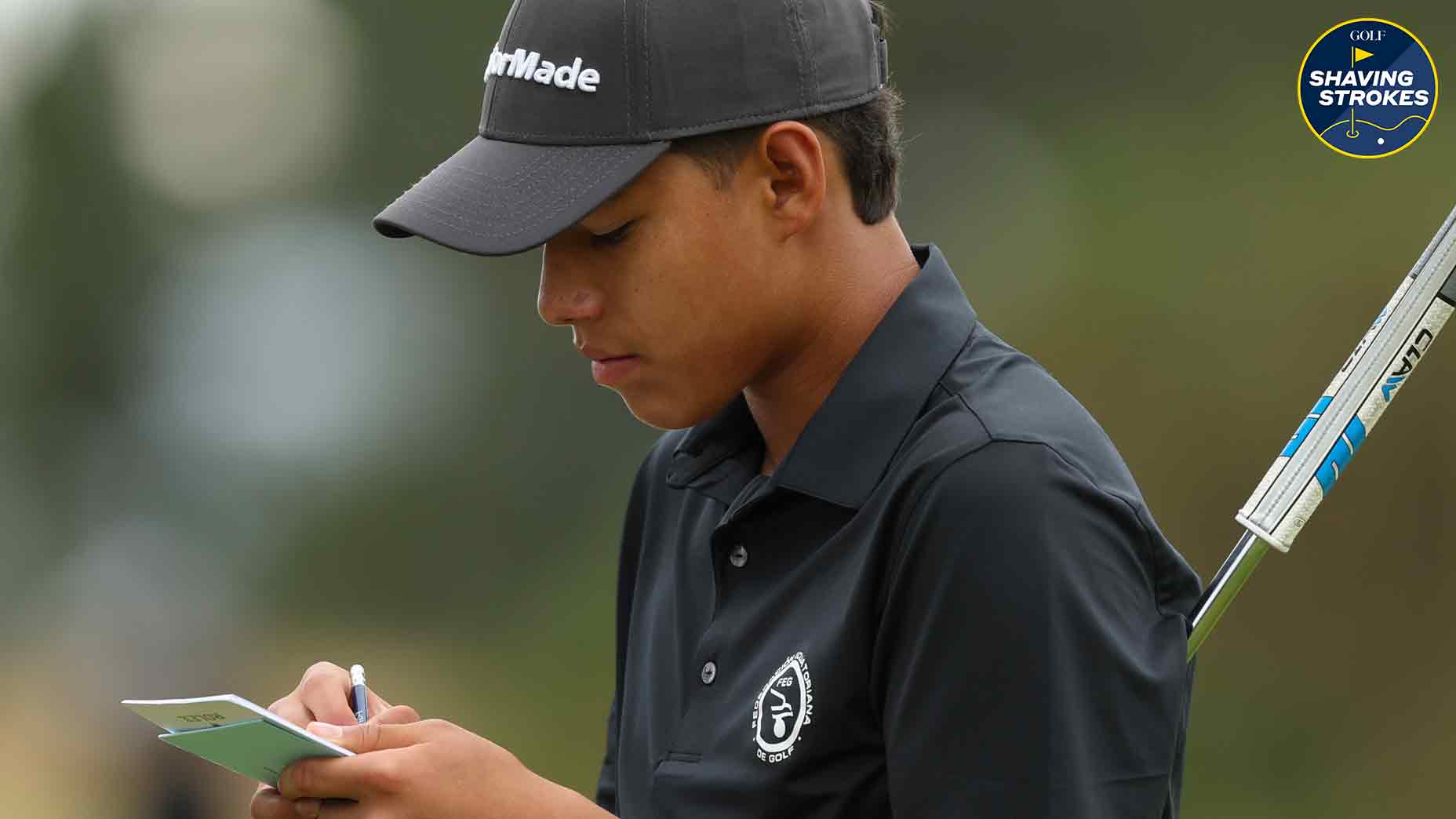 Pro golfer looks at scorecard during golf round