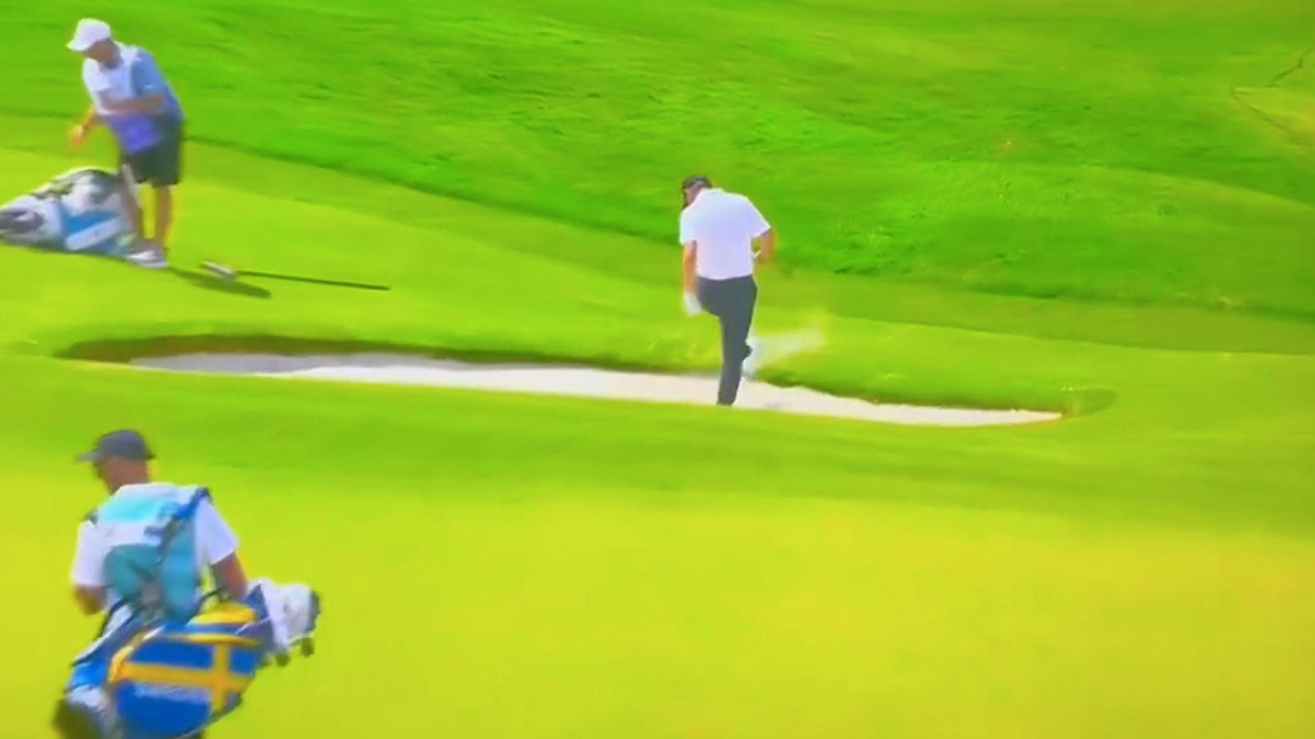 Pro golfer Emilino Grillo swings a club into a bunker Friday at the 2024 Olympics.