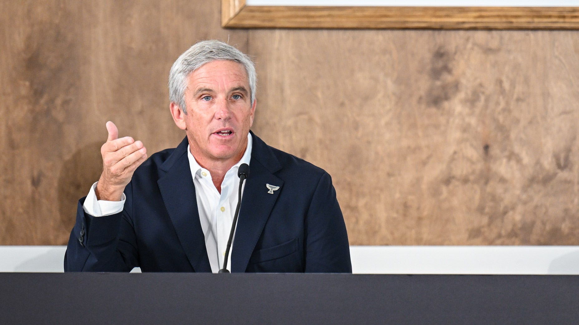 jay monahan speaks at tour championship press conference in suit with unbuttoned shirt