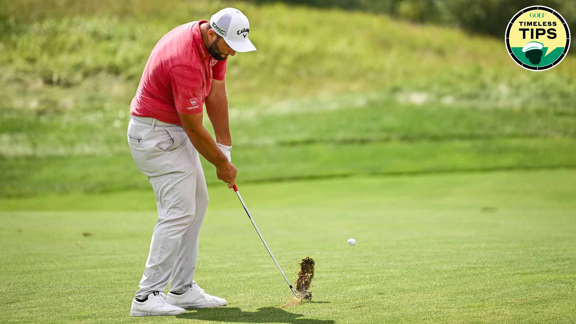 jon rahm takes a divot from the fairway