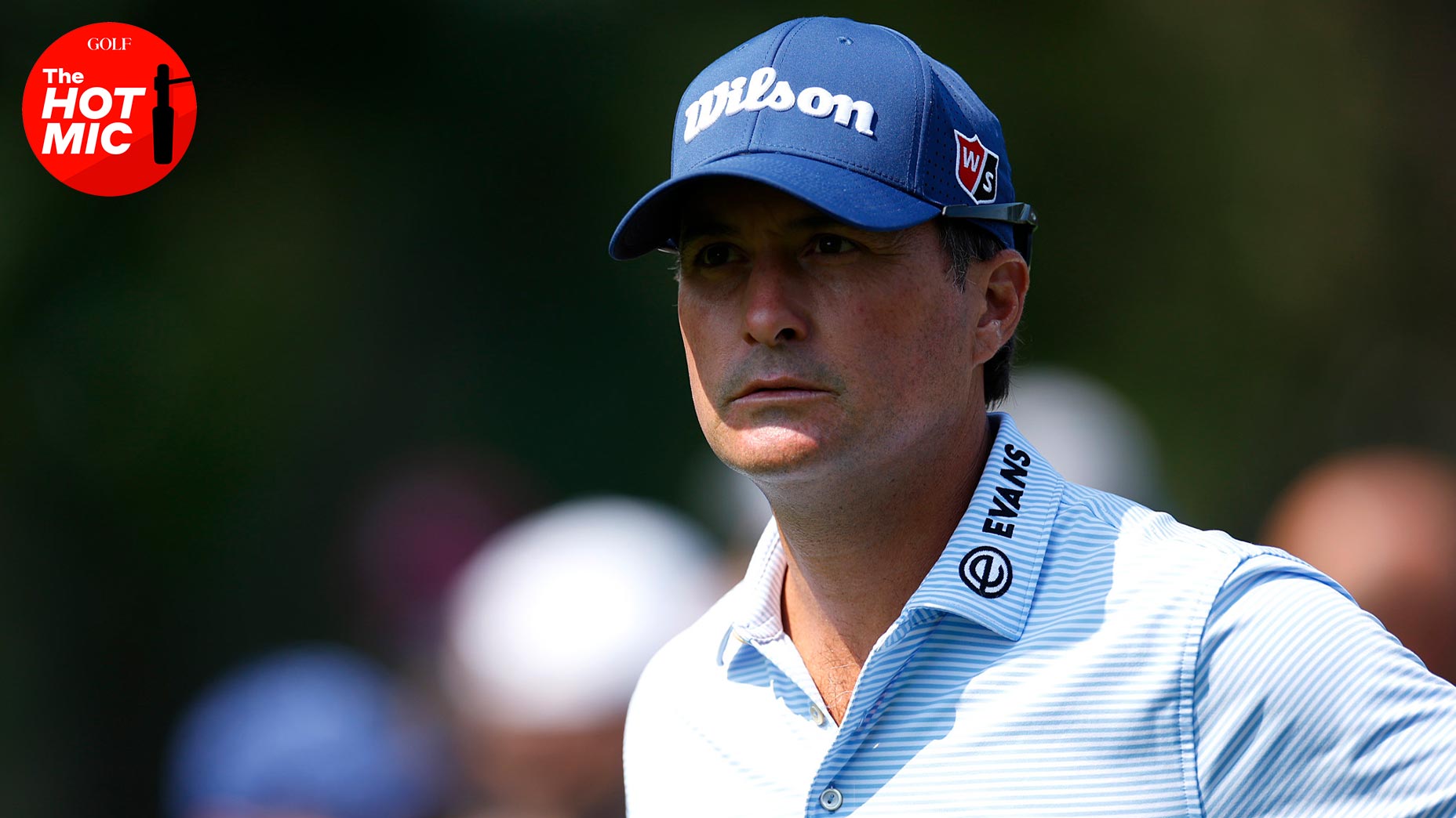 Kevin Kisner stares into the distance in a blue shirt and navy blue cap