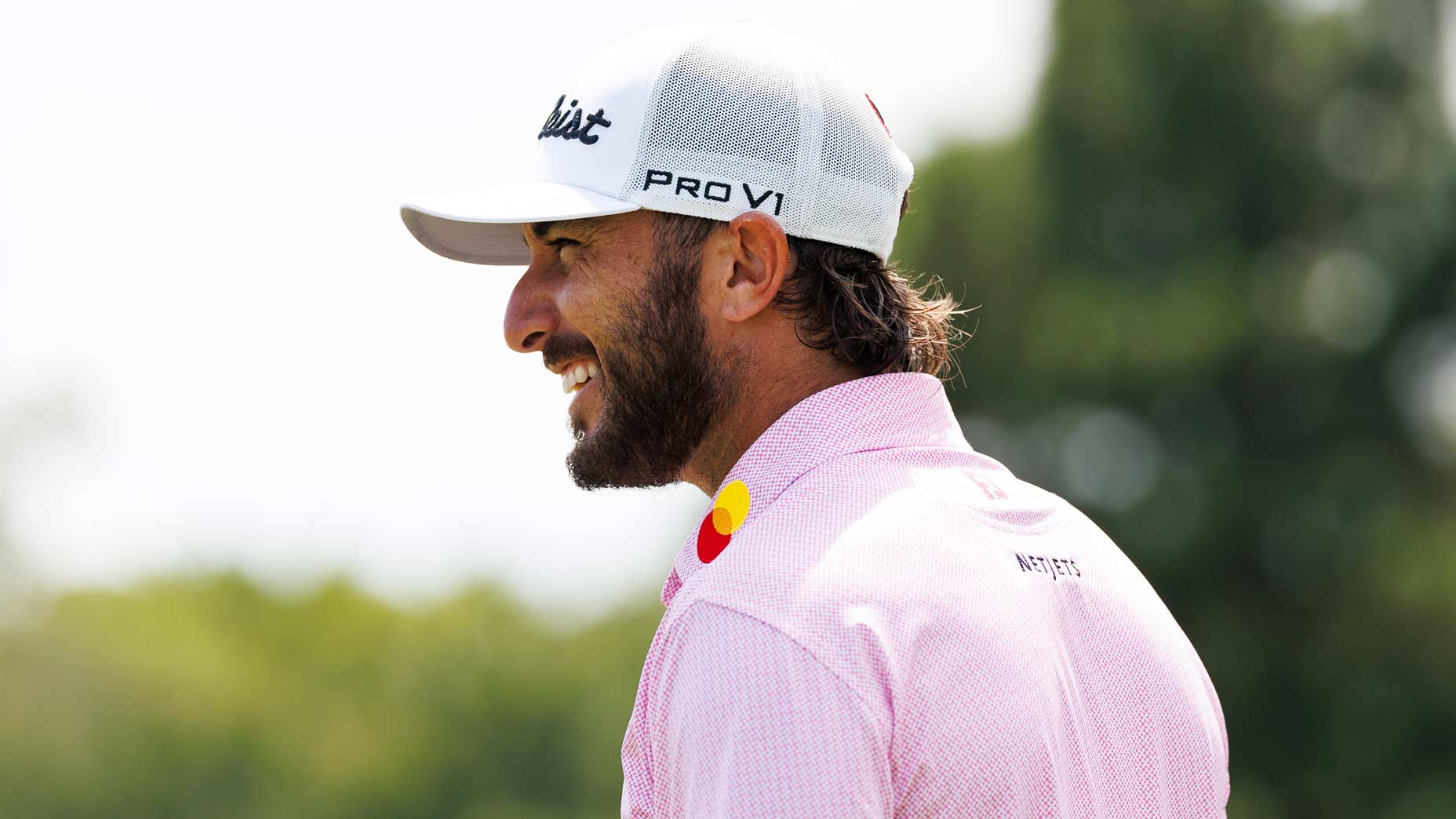 Close-up photo of pro golfer Max Homa laughing during PGA Tour event