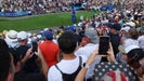 Fans at Le Golf National watch American Scottie Scheffler tee off at 2024 Olympics.