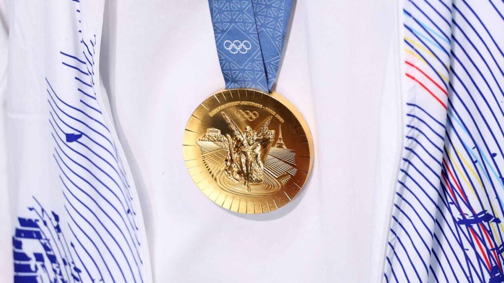 A close-up photo of gold medal hanging on Olympian at 2024 Paris Olympics.