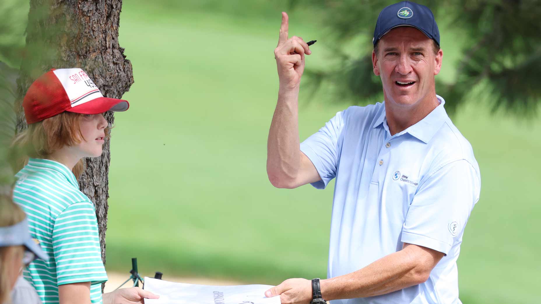 Peyton Manning signs autographs for fans during the 2024 BMW Championship Pro-Am.