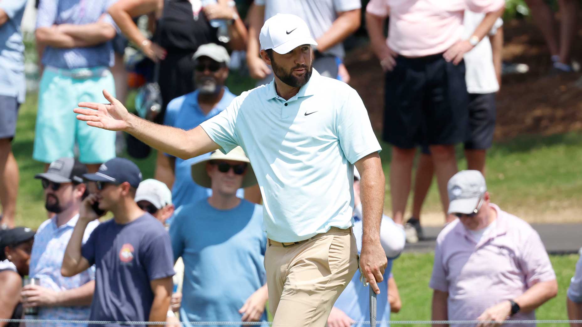 Pro golfer Scottie Scheffler gestures after putt at 2024 FedEx St. Jude Championship.