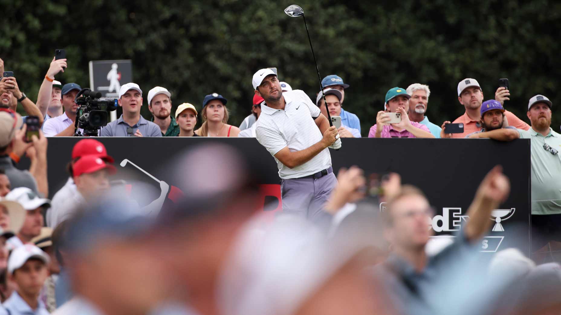 Pro golfer Scottie Scheffler hits his shot from the 18th tee during the third round of the 2024 Tour Championship at East Lake Golf Club.