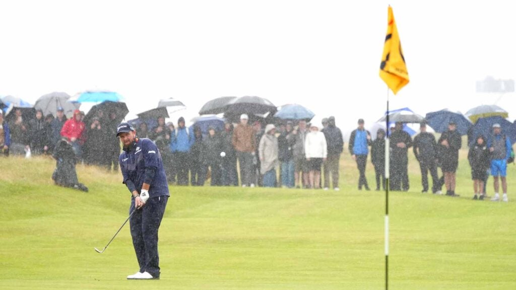 shane lowry hits chip shot in the rain during the 2024 open championship