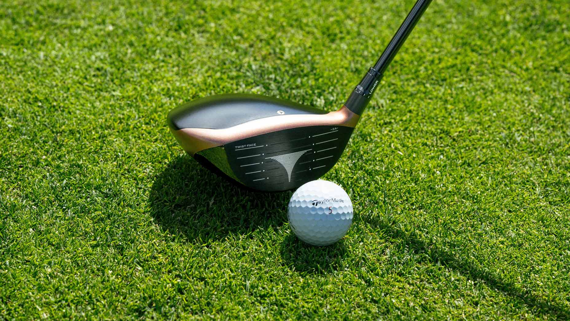 TaylorMade BRNR Copper Mini driver at address with a golf ball on the golf course