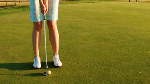 a woman on the putting green