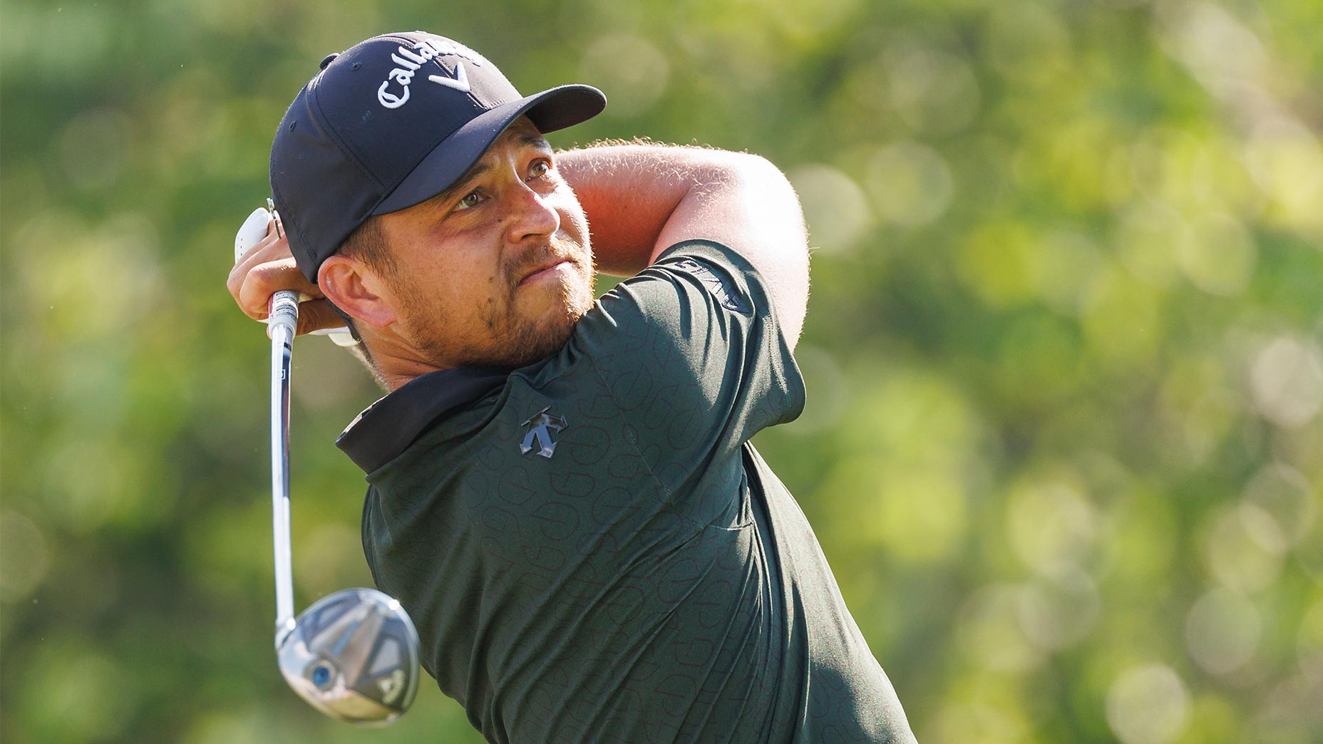 xander schauffele swings club in green shirt at fedex st jude tournament