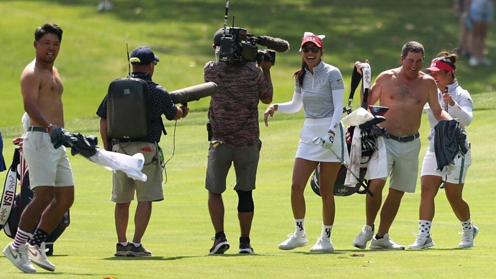 Alison Lee and Megan Khang react with their caddies.