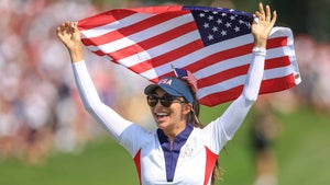 alison lee holds an american flag above her head in celebration of winning the solheim cup