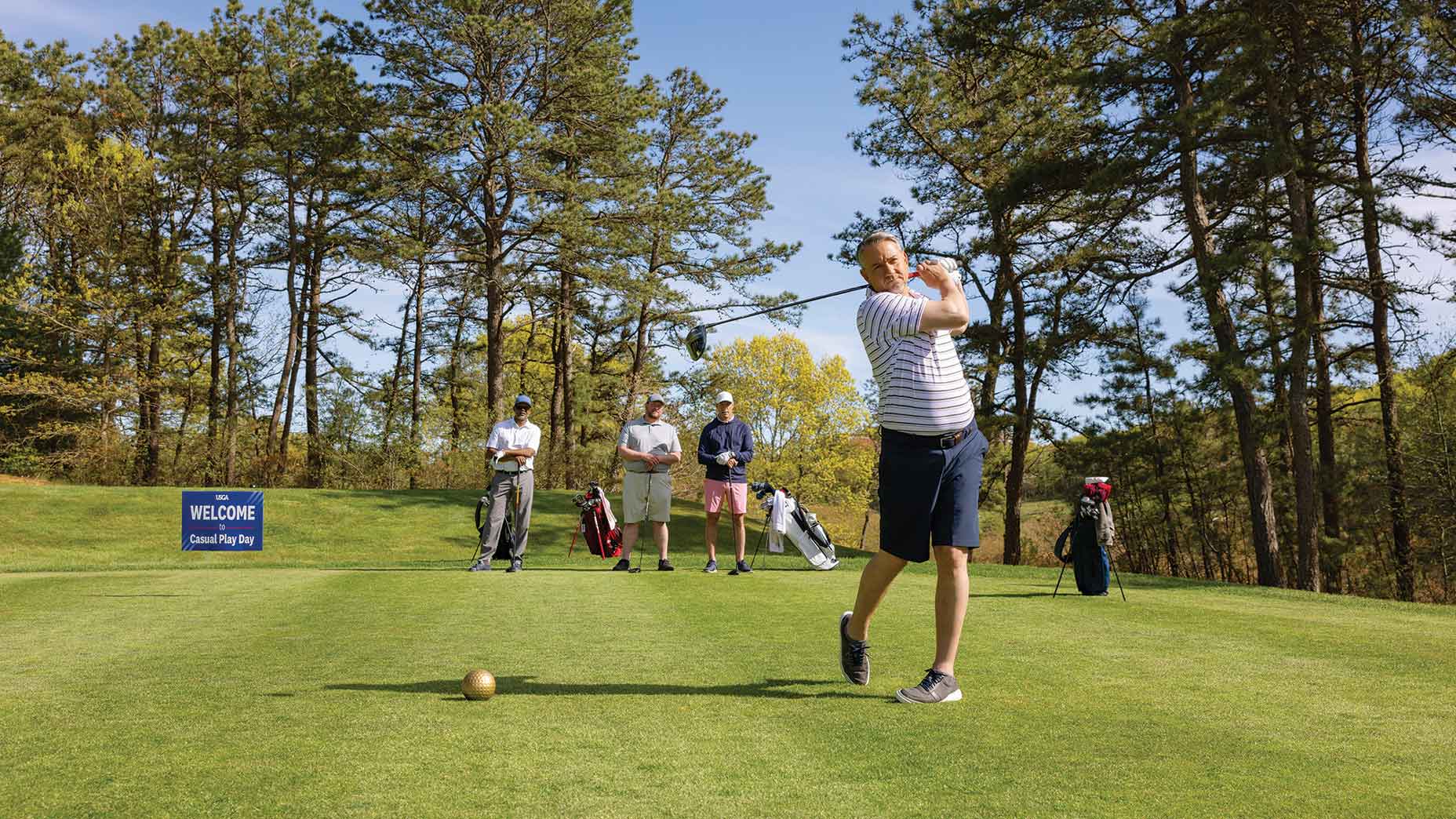 Golfer holds finish after derive on golf course