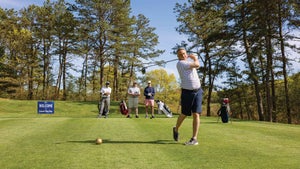 Golfer holds finish after derive on golf course