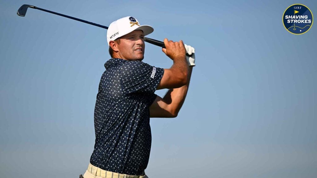 Pro golfer Bryson DeChambeau watches his tee shot at golf tournament.