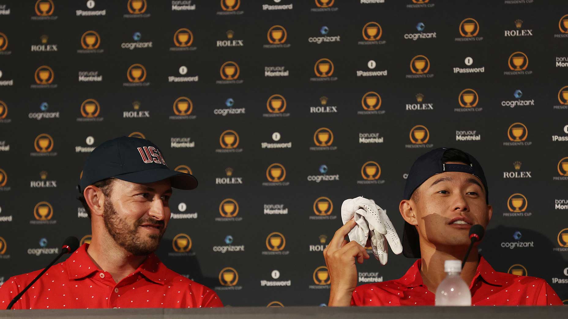 collin morikawa raises his golf glove in celebration of the President's Cup victory next to a smiling patrick cantaly