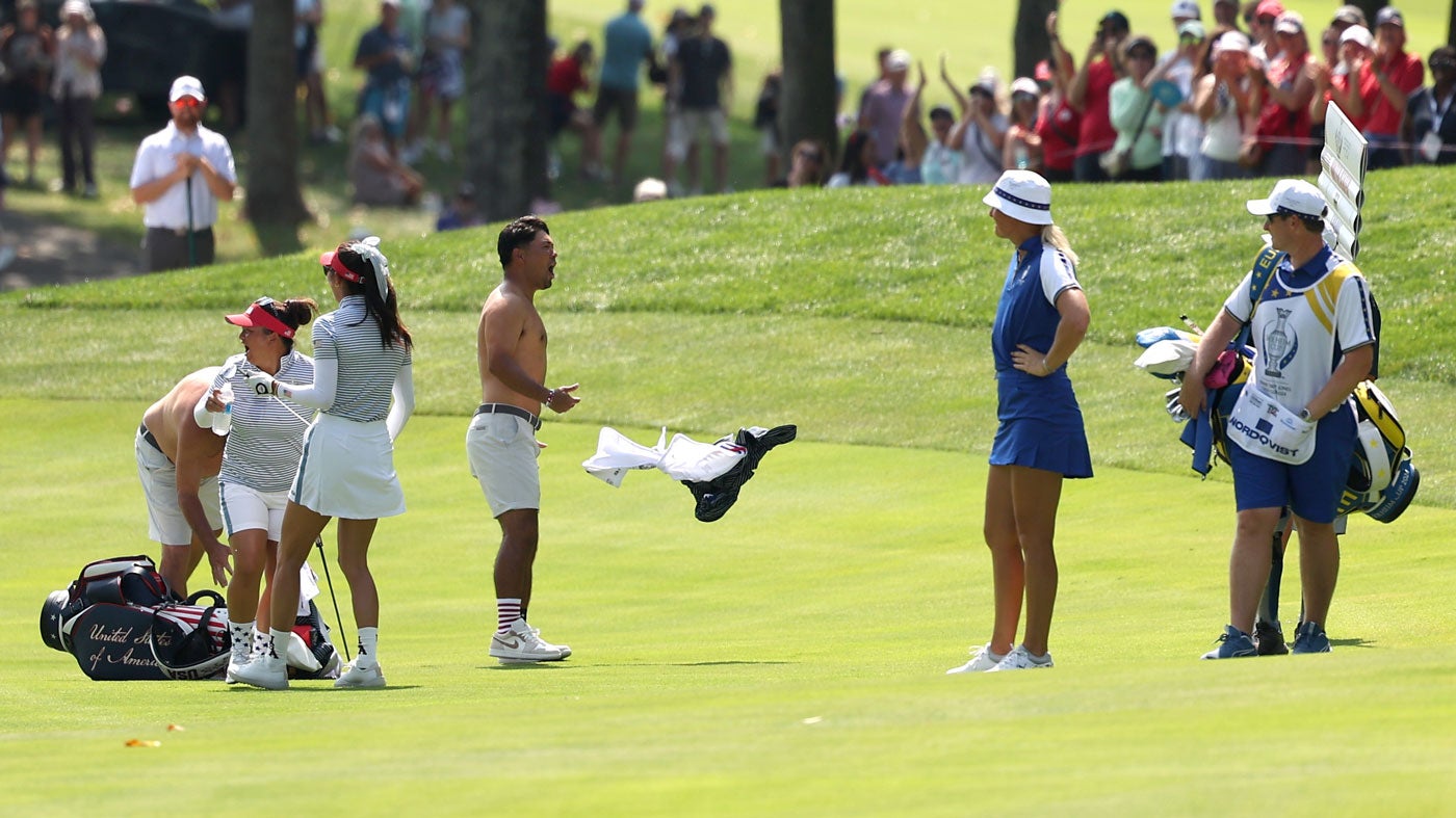 Caddies celebrate after Alison Lee hits an eagle at the Solheim Cup