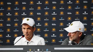 mike weir stares in white hat at presidents cup press conference next to geoff ogilvy