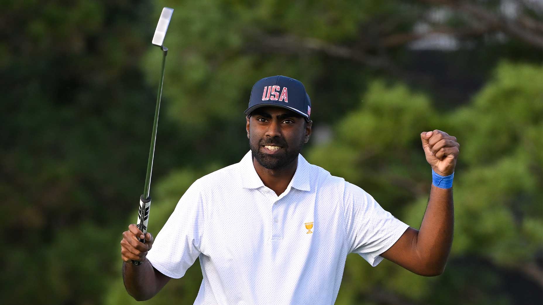 sahith theegala smiles with putter in his hands at the presidents cup in white shirt