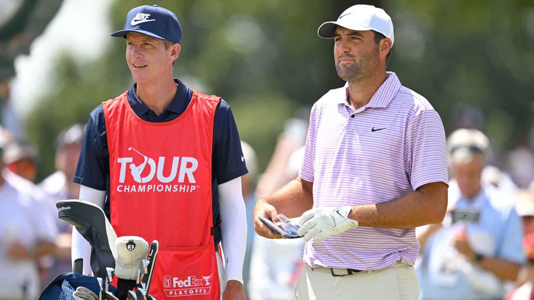 Scottie Scheffler talks with caddie, Ted Scott, on the first tee box during the first round of TOUR Championship at East Lake Golf Club on August 29, 2024 in Atlanta, Georgia.