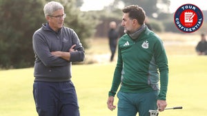 Jay Monahan and Yasir Al-Rumayyan talk on the golf course.